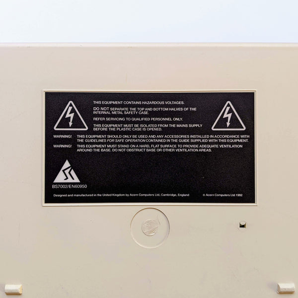 Acorn Archimedes A3010 "hazardous voltages" warning label